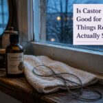 Castor oil beside strands of hair arranged for a hair care article